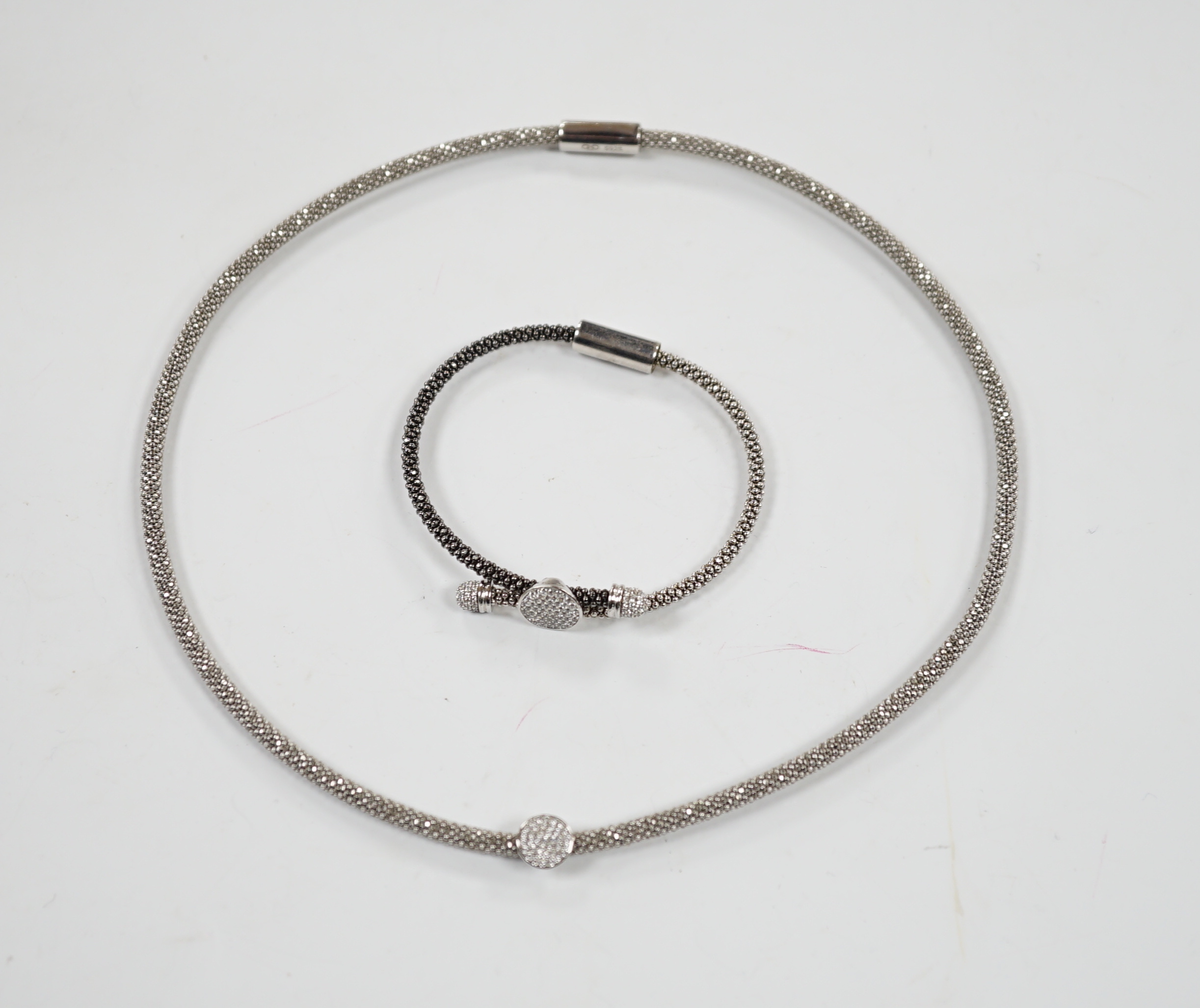 A modern Links of London, silver necklace with diamond cluster motif and a similar bracelet, in Links of London box.